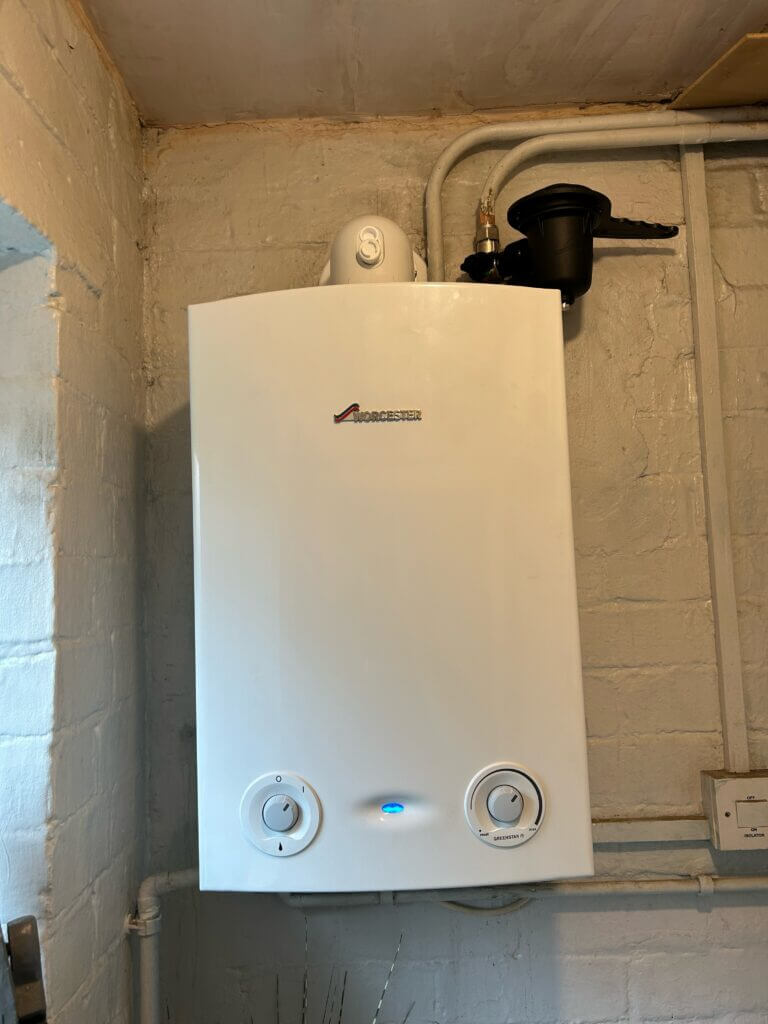 New gas boiler installation with a vertical flue going through the ceiling